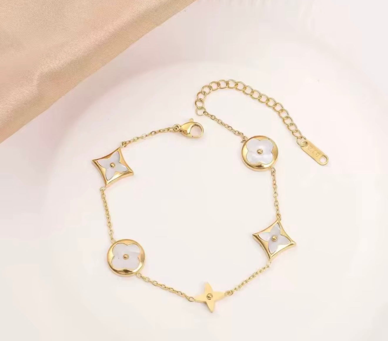 White diamond with gold bracelet